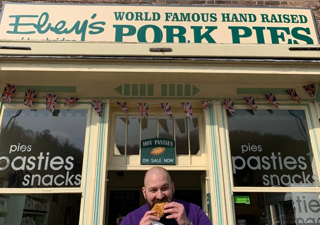 Eating a pork pie outside Eley's World Famous Hand Raised Pork Pies